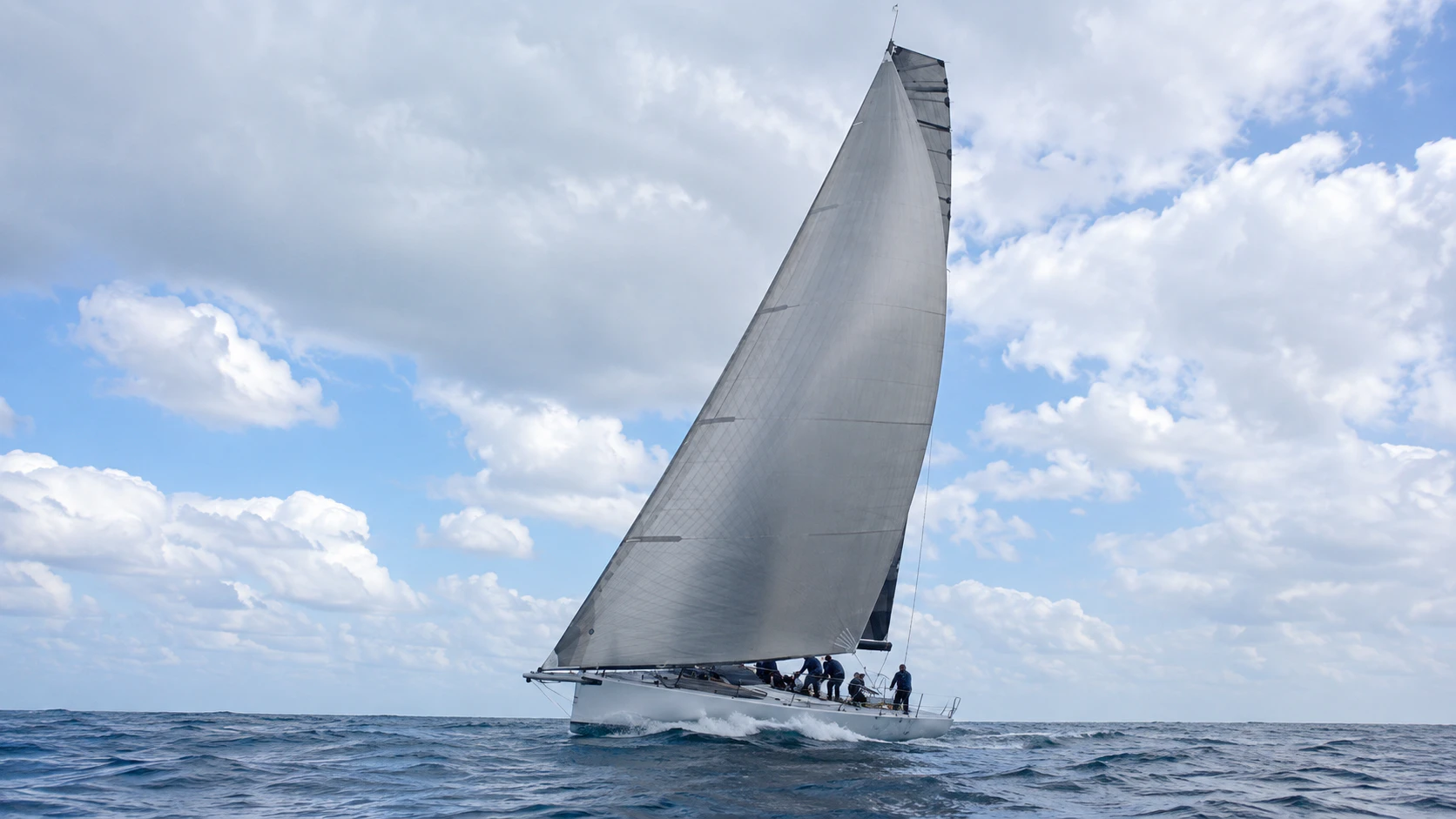 Performance yacht sailing under a light gray Code Zero