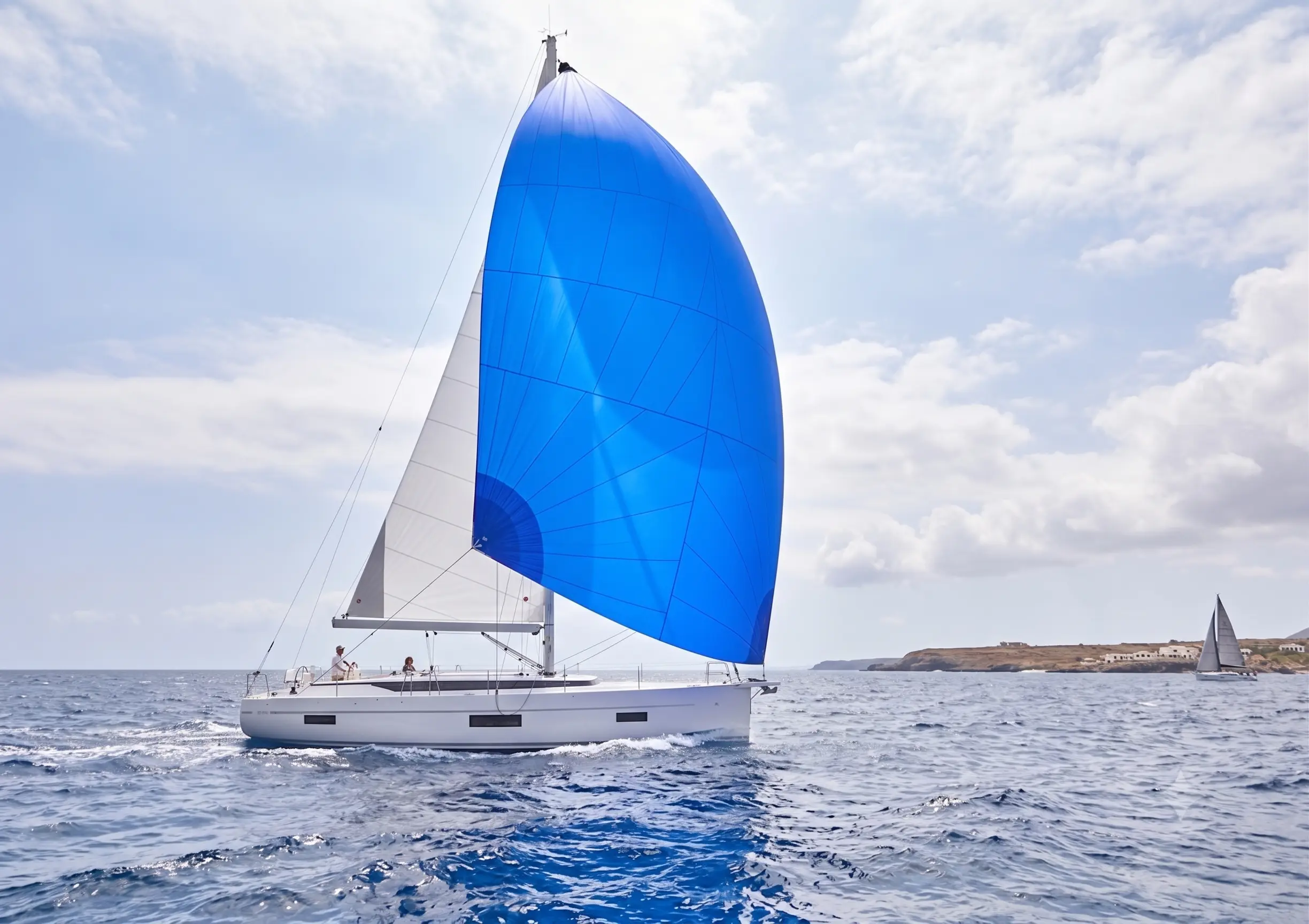 Blue gennaker flying from a cruising yacht