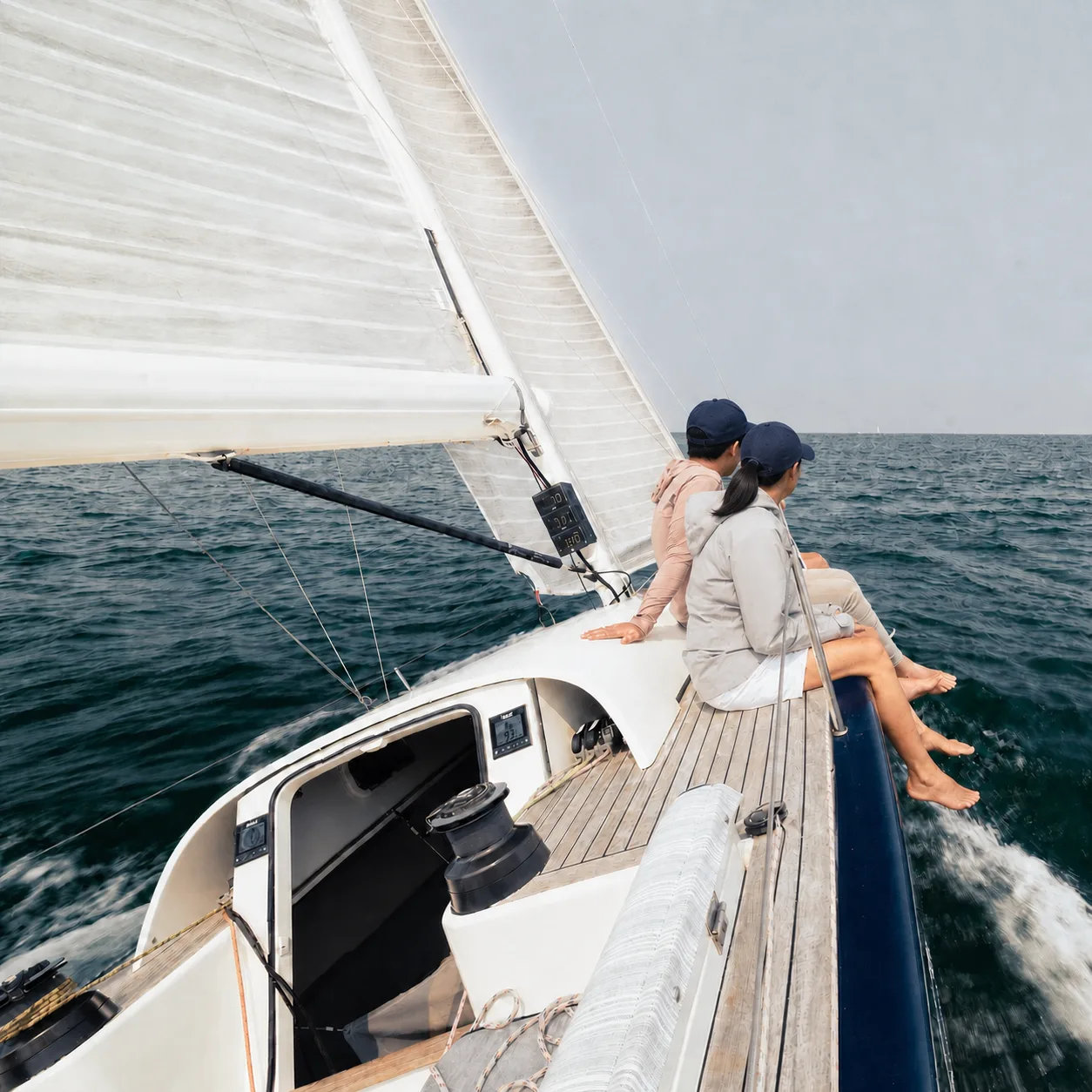 Cruising yacht under sail with sailors on deck