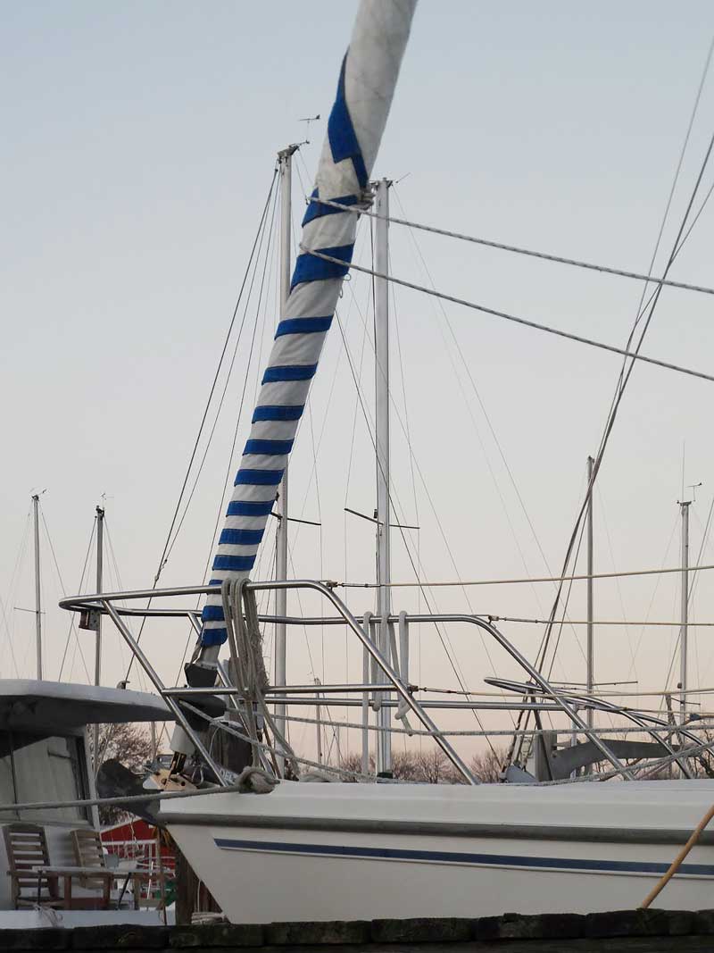 A furling headsail with a UV cover on the leech