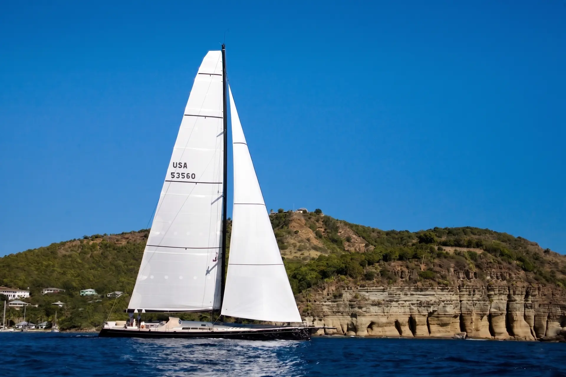 Dark sail number and country code applied to a white mainsail
